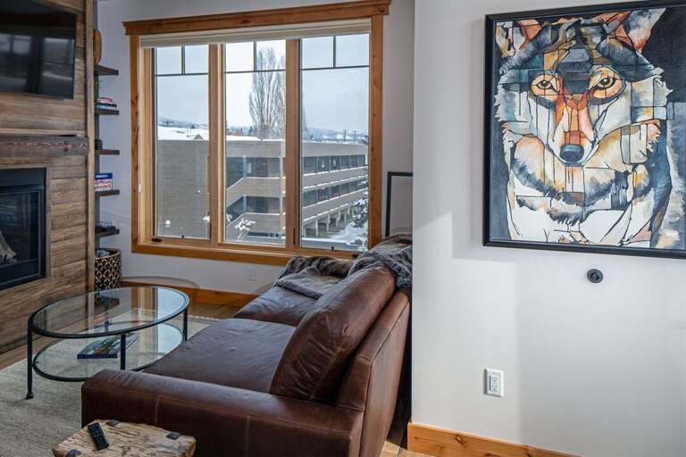 O`Brien View living room features a portrait-style television, a gas fireplace & oversized couch | Main Level O`Brien View living room features a portrait-style television, a gas fireplace & oversized couch | Main Level